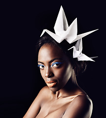 Image showing Cosmetics, portrait and black woman in studio with origami birds for honor with glamour aesthetic. Dark background, female person and African girl with makeup, glow and shine for natural beauty