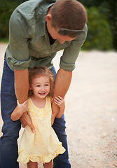 Image showing Child, smile and outdoor park with father for summer vacation, adventure or weekend holiday trip. Happiness, young girl and male person playing together for love, support and bonding in nature