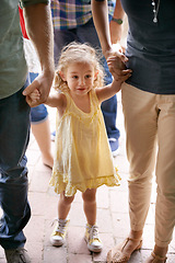 Image showing Happy, young girl and family holding hands for travel, fun adventure or holiday weekend in nature. Excited child, mom and dad walking outdoors for sightseeing, bonding and field trip together