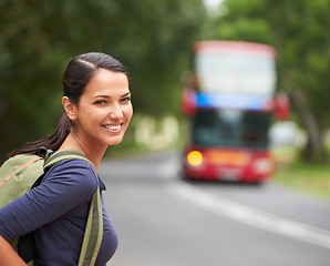 Image showing Woman, backpack and portrait with waiting for bus with smile on travel, journey or vacation in summer. Girl, person and tourist with luggage, happy and outdoor on metro sidewalk for transportation