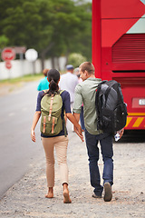 Image showing Couple, holding hands and bus for travel on vacation with back, walking and luggage in street with chat. Man, woman and people with connection, love and bonding on holiday for road trip in Costa Rica