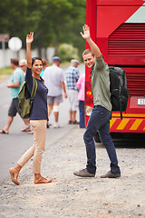 Image showing Couple, happy and wave for bus, travel and backpack for adventure, journey or transportation on street. Man, woman and smile outdoor in portrait with vehicle for road trip for vacation in Costa Rica
