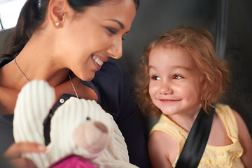 Image showing Taxi, love or mother and daughter in a car for adventure, road trip or bonding with teddy bear games. Happy, family and kid with mom in a backseat of cab with care, trust and safety, travel or fun