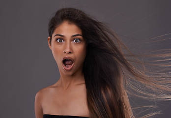 Image showing Portrait, woman or shock in wind as haircare, beauty or announcement of salon,hairdressing or promo. Long, natural or strong hairstyle in wow, wtf and omg for result or benefit of treatment in studio