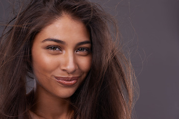 Image showing Portrait, confident woman or messy hair in wind, damage or treatment in studio on grey background. Grooming, frizz and tangle in simple keratin female model for dull and dry texture and scalp