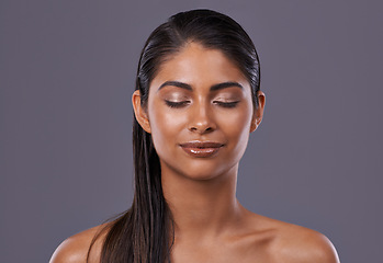Image showing Skincare, glow and woman with makeup, closed eyes and dermatology on grey studio background. Person, model and girl with grooming routine or texture with treatment or shine with aesthetic and beauty