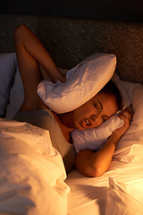 Image showing Woman, bedroom and pillow at night with insomnia for annoyed noise in apartment for stress, nightmare or frustrated. Female person, bedding and light on mattress with headache, problem or anxiety
