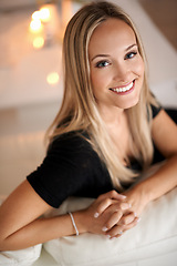 Image showing Portrait, woman and smile on couch in living room, wellness and candles for peace in apartment. Face, positive and blonde lady to relax on sofa, mindfulness and tranquility on weekend night in home