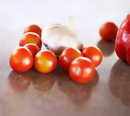 Image showing Kitchen counter, home and vegetable recipe to cook for healthy, meal and nutrition for wellbeing and diet. House, fresh and organic food for dinner with tomato and garlic to prepare for soup.