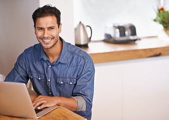 Image showing Website, research and internet for man with laptop on table in kitchen for online, web and info for work. Entrepreneur or freelancer and smile with keyboard for tech, typing and email with mockup