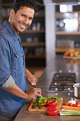 Image showing Food, home and cooking for man in kitchen with vegetables on counter for health, diet or recipe for dinner. Chef, vegan and smile with knife and ingredients on board for soup, eating and mockup