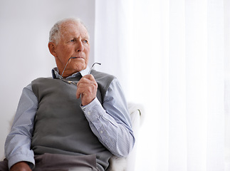 Image showing Old man, thinking and lonely for depression on couch, glasses and remember memories or mistake. Senior male person, living room and nostalgia or anxiety on sofa, dementia and Alzheimer in retirement