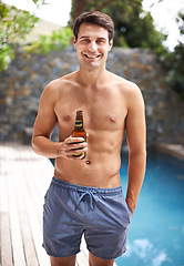 Image showing Portrait, man and happy by swimming pool with beer to relax or chill on summer vacation, luxury and resort or villa. Male person, bottle and alcohol for refreshments on tropical holiday in Maldives.