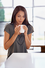 Image showing Woman, coffee and mug with kitchen, blow and morning for home routine. Person, cup and tea with house, beverage and aroma for relax and caffeine or taste and drinking to enjoy break with happiness