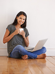 Image showing Floor, laptop and portrait of woman blogging with smile by wall background of apartment with tea or coffee. Happiness, female person and girl online on app writing novel with internet connection