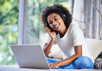 Image showing Headphones, woman and laptop at home for online education, e learning and homeschooling in living room. Female person, scholar and university student in house for remote class, studying and tuition