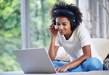 Image showing Black woman, headphones and laptop at home for online teaching, e learning and education in living room. Female person, scholar and university student in house for remote class, studying and tuition