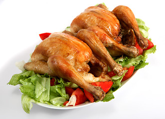 Image showing Two roast chickens on a bed of salad