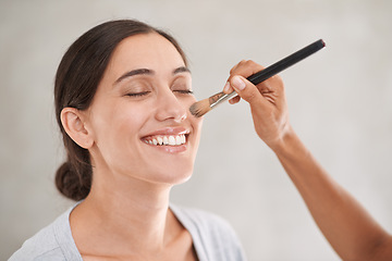 Image showing Happy woman, brush and makeup artist hand for beauty, cosmetology and foundation application on white background. Powder, shimmer and cosmetic care at professional salon with model for shine