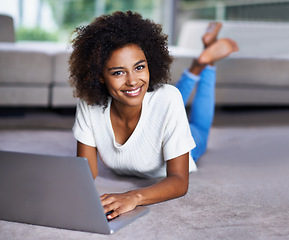 Image showing Carpet, laptop and portrait of woman on floor working on freelance creative project in living room. Happy, technology and African female designer typing on computer for research on rug in apartment.