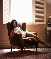 Image showing Woman, sexy and thinking in chair at home, relax and underwear for elegant calm female person. Confident, feminine or sensual comfort, fashion and lady by window in lounge with natural light