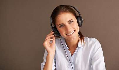 Image showing Portrait, customer service and sales consultant in studio professional, formal and working with headset. Call center, woman and talk with clients for support, advise and help in mockup space