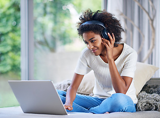 Image showing Headphones, university student and laptop at home for online education, e learning and teaching in living room. Female person, computer and black woman in house for remote class, studying or tuition