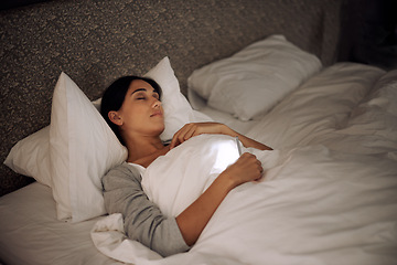 Image showing Woman, phone and sleep in peace, bed and relaxation under blankets in pajamas for wellness. Female person, laying and rest for home, night and dreaming in sleepwear for comfort and social media