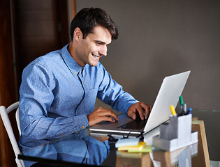 Image showing Businessman, laptop and typing in office professional, salesman and working in workplace. Male person, smile and happy with computer or research, corporate and technology for connectivity or project