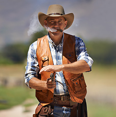 Image showing Cowboy, portrait and aim gun to shoot for standoff or gunfight in duel for wild western culture in Texas. Male gunslinger or outlaw, revolver and confrontation for defense or conflict with battle