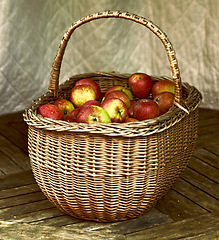 Image showing Closeup, apple and basket for autumn, still life and artwork of healthy, food or agriculture. Organic, fruit and floor for ecosystem, sustainability or zero waste for natural eco friendly snack