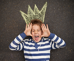 Image showing Chalk art, funny face or boy with crown on floor for drawing, imagine or future fantasy on black background. King, emoji or kid with royalty, sketch prince or dream for school, project or assignment