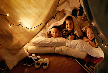 Image showing Children, smile and playing in blanket fort with portrait for fantasy, bonding and string lights at night. Friends, kids and face or happy for pajama party, sleepover and pillow tent with lighting