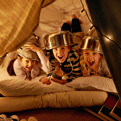 Image showing Children, portrait and siblings with pot helmet in a fort for fantasy, learning or playing in their home. Happy family, face and kids on a floor with tent games, development or fun bonding in a house