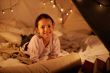 Image showing Happy, portrait and girl in a bedroom fort in a house for holiday, games or staycation fun. Face, smile and happy kid in a diy tent for playing, resting or enjoy weekend with camping fantasy in house