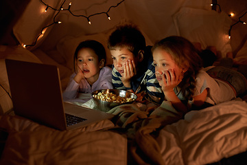 Image showing Children, laptop and watch in tent at night with movies, film or cartoons for holiday adventure or vacation. Young boy, girl or kids with lights, pillows and blanket at home on computer for Netflix