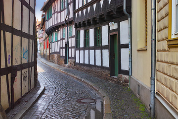 Image showing Narrow, alley and building in road, Germany and historic cobble stone street or architecture in village for tourists. Structure or traditional design, creative home in old town real estate or path