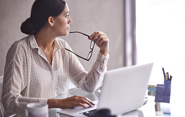 Image showing Businesswomen, thinking and glasses at office, desk and laptop for corporate worker. Technology, computer or contemplating for female accountant, online and working on budget and finance research