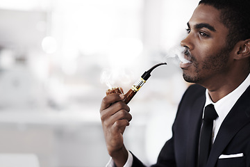 Image showing Businessman, smoking and vaping in office electronic cigarette and tobacco in formal clothes or outfit. Black man, corporate and thinking or ideas in workplace and salesman in company or career