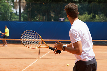 Image showing People, playing and competition on tennis court, athlete and action with ball to score. Opponent, intensity and training in set in tournament, fitness and target of professional player in summer game