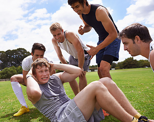 Image showing Man, sit ups for workout and cheers from team with support and coaching, fitness and training on sports field. Challenge, action and core exercise outdoor with athlete friends, motivation and help