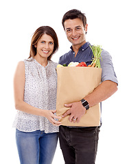 Image showing Happy couple, portrait and bag with groceries for food, natural sustainability or fashion on a white studio background. Man and woman with smile for grocery shopping, casual clothing or supermarket