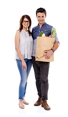 Image showing Happy couple, portrait and grocery bag with vegetables for food, natural sustainability or nutrition on a white studio background. Young man and woman with smile for healthy ingredients or shopping