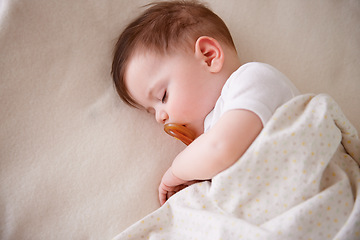 Image showing Baby, sleeping and home with tired, sleepy and nursery with peace in a bed with blanket. Morning, youth and kid with dream of an infant with child development from rest in a bedroom with a newborn