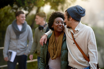 Image showing Students, university and talking of interracial couple of friends on campus with hug and an embrace together. College, school education and diversity with a happy smile ready for class outdoor