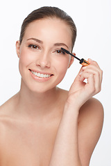 Image showing Mascara, portrait and woman with makeup for beauty, cosmetic product for lashes and volume on white background. Wand, eyelash care with smile and skin glow, change or transformation in studio