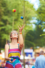 Image showing Camping, festival and juggle with woman in park for event, party or celebration in summer environment. Nature, forest or woods with young person in glasses juggling balls outdoor at social gathering