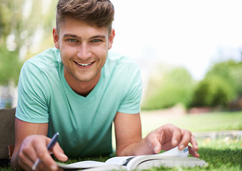 Image showing Man, studying and books on grass for portrait, smile and pride for learning, development and reading. Person, university student and happy with notes, information and knowledge for college education