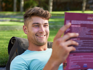 Image showing Man, student and book on lawn for reading, smile and ideas with learning for development at campus. Person, studying and happy with scholarship, information and knowledge for education at college