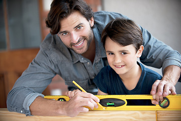 Image showing Father, kid and woodwork at home for portrait, bonding and building with safety gear. Dad, son and carpenter for renovating, measuring and teaching moment for development of house with construction